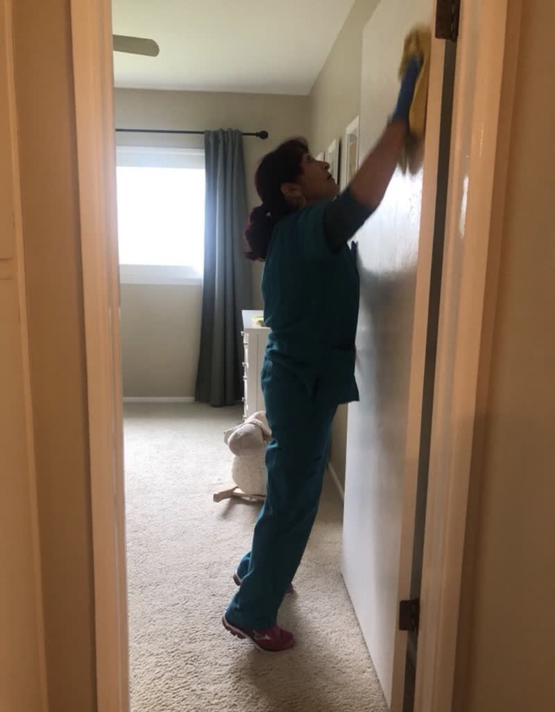 Cleaner wiping a door frame